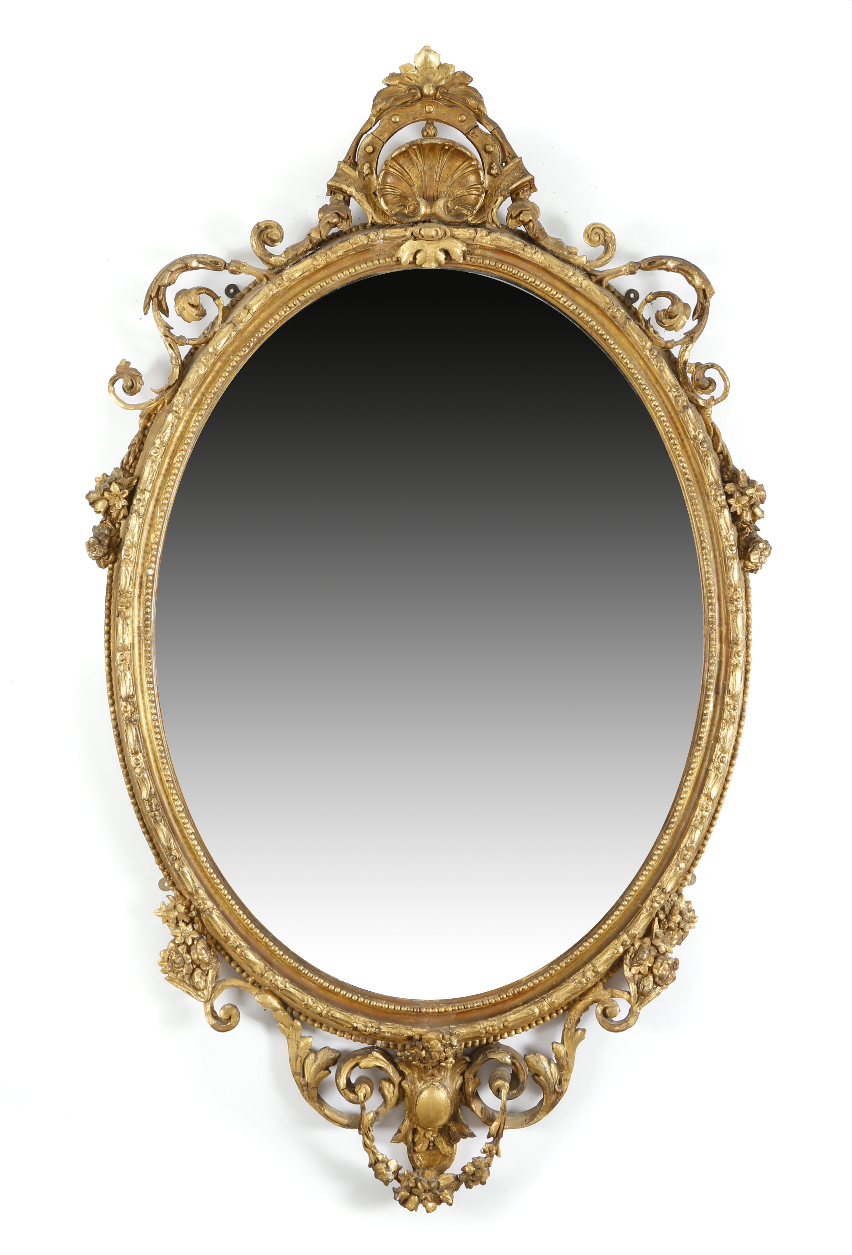A VICTORIAN GILTWOOD AND GESSO WALL MIRROR C.1860 the oval plate within a beaded inner frame, with a