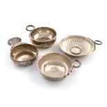 A small collection of four silver wine tasters, comprising: a French one of circular form, the