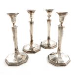 A matched set of four George III silver candlesticks, two by Smith and Sharp, London 1787, two by