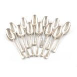 A matched set of twelve early 18th century silver Hanoverian Rat-tail pattern dessert spoons, eleven