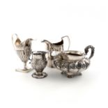 A collection of four George III/IV silver cream jugs, comprising: one of baluster form, embossed