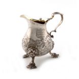 A George II silver cream jug, by Thomas Parr, London 1741, baluster form, chased foliate