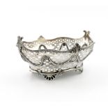 An Edwardian silver basket, by Charles Stuart Harris, London 1903, oval form, pierced with mullets