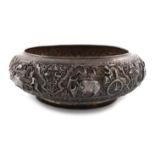 An Indian silver bowl, shallow circular bellied form, chased with various scenes with elephants,