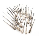 A collection of twenty-five silver handled button hooks, various dates and makers, the handles