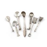 A collection of seven Victorian novelty silver salt spoons, comprising: one modelled as a besom