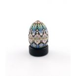 A Russian silver-gilt and enamel egg, 1896-1908, with pink and blue/green decoration on a matted
