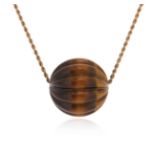 A tiger's eye pendant, the carved tiger's eye bead suspends from a gold ropetwist necklace, bead 3.
