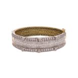 A diamond-set gold bangle, set with princess-cut and round brilliant-cut diamonds