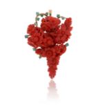 A coral and emerald-set brooch pendant, composed of a series of coral tiered floral clusters with an