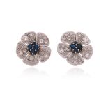 A pair of sapphire and diamond flowerhead earrings, centred with circular-cut sapphires, the