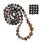 A graduated banded agate bead necklace, 76cm, and a low carat gold brooch set with sixteen round