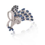 A sapphire and diamond spray brooch, the stylised spray set with marquise and circular-cut sapphires