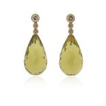 A pair of quartz and diamond drop earrings, each briolette-shaped quartz suspends from an