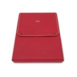 A red leather necklace case by Cartier, the textured red leather hard case with four soft folding