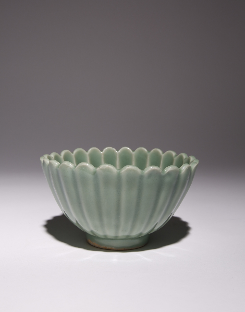 A GOOD CHINESE LONGQUAN CELADON 'CHRYSANTHEMUM' BOWL MING DYNASTY The deep fluted sides moulded as