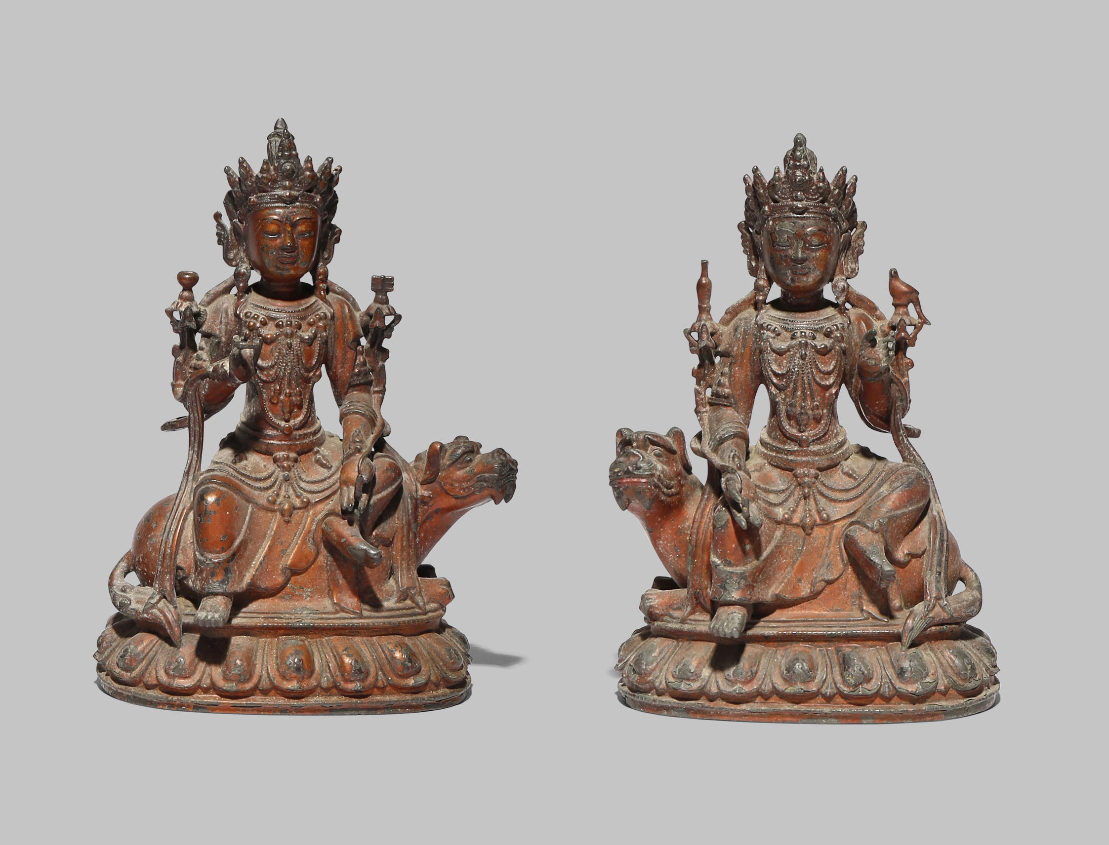 A PAIR OF CHINESE LACQUERED-BRONZE FIGURES OF BODHISATTVAS LATE MING DYNASTY Each seated upon a