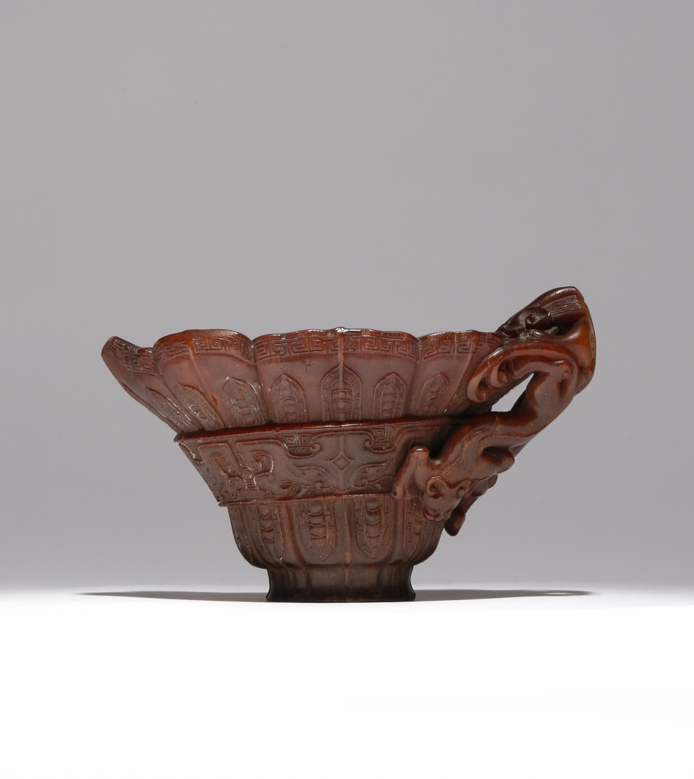 λ A CHINESE ARCHAISTIC RHINOCEROS HORN 'CHILONG' LIBATION CUP 17TH/18TH CENTURY Carved to the - Image 2 of 3