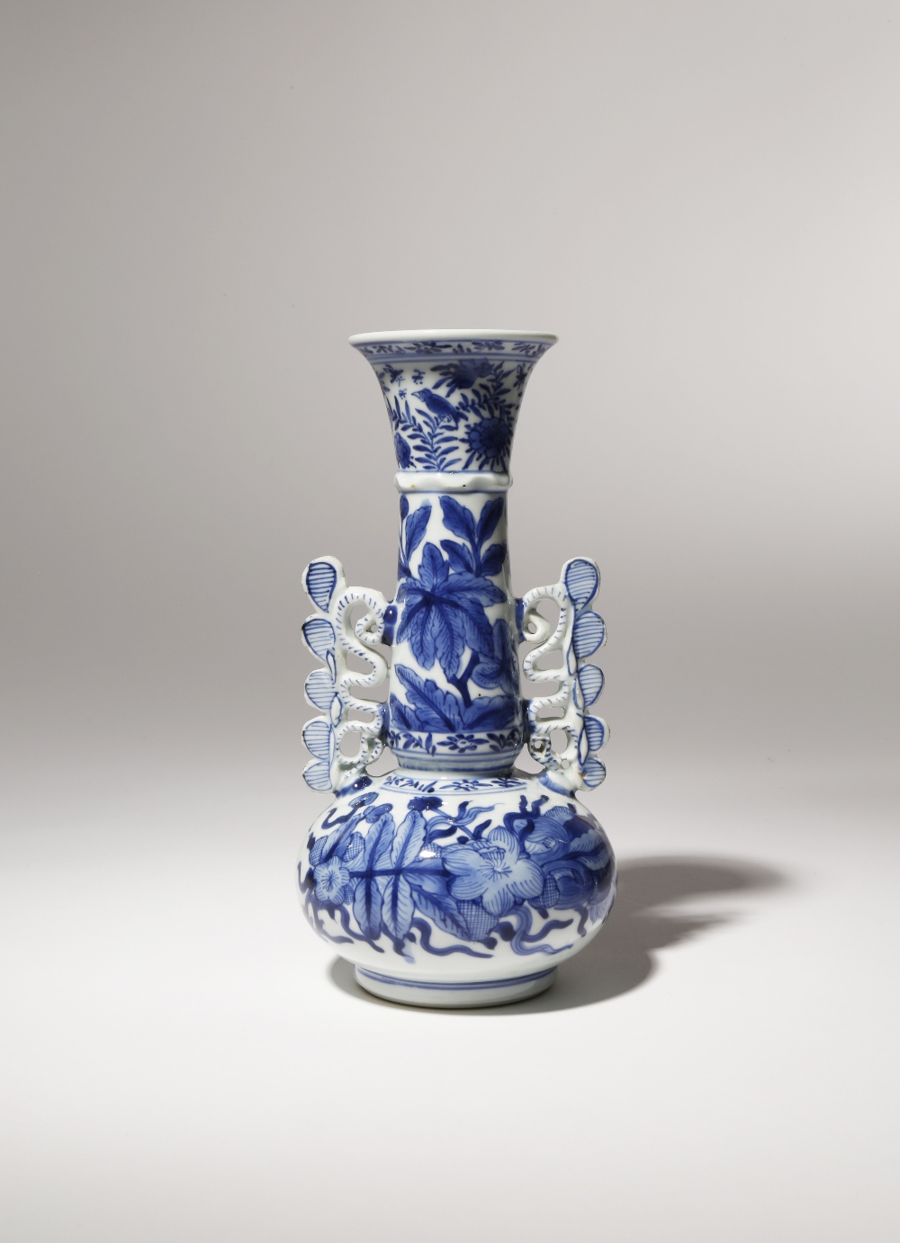 A CHINESE BLUE AND WHITE VENETIAN GLASS STYLE BOTTLE VASE KANGXI 1662-1722 The compressed circular