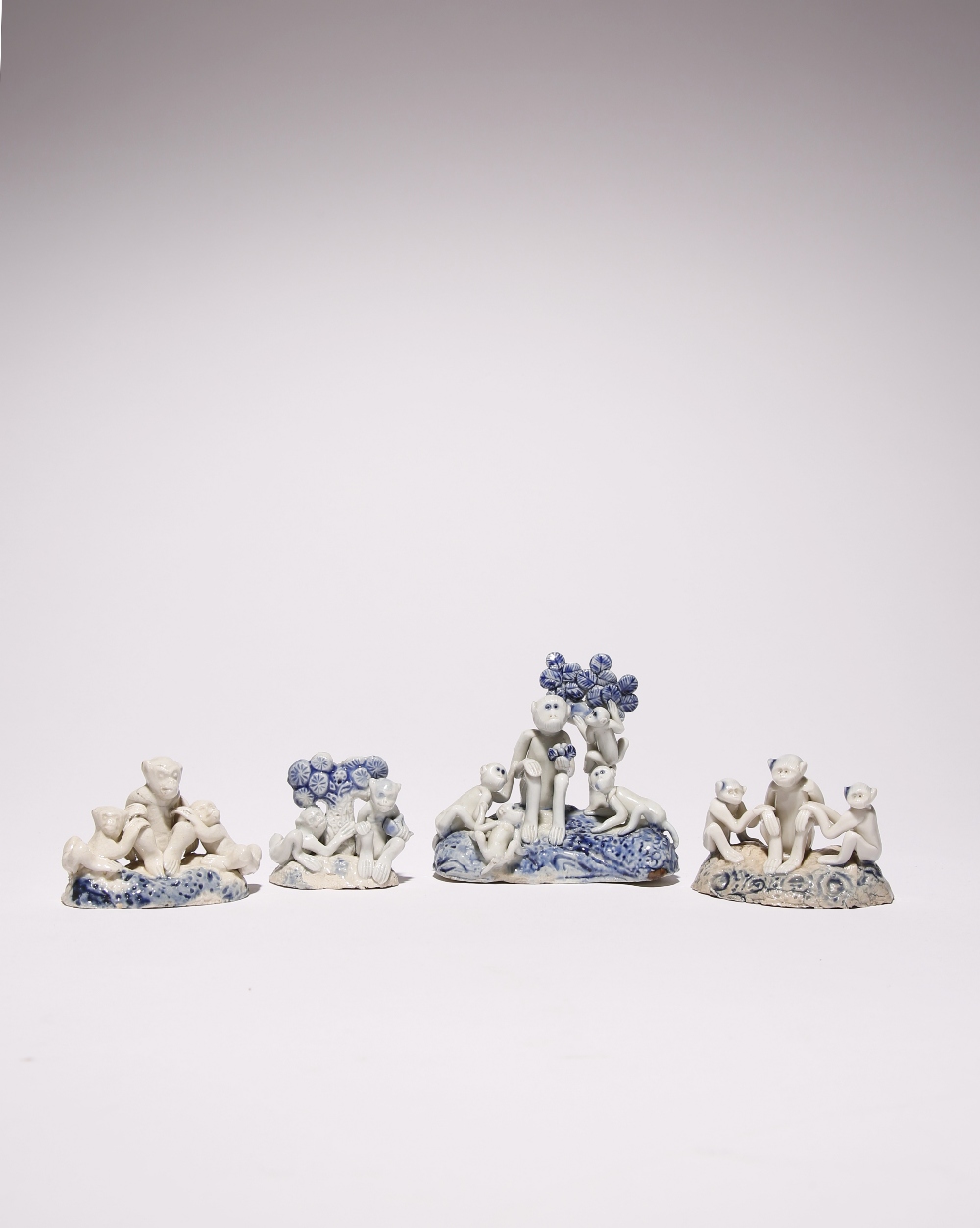 FOUR UNUSUAL JAPANESE HIRADO PORCELAIN MODELS OF MONKEYS MEIJI PERIOD, 19TH CENTURY Two groups