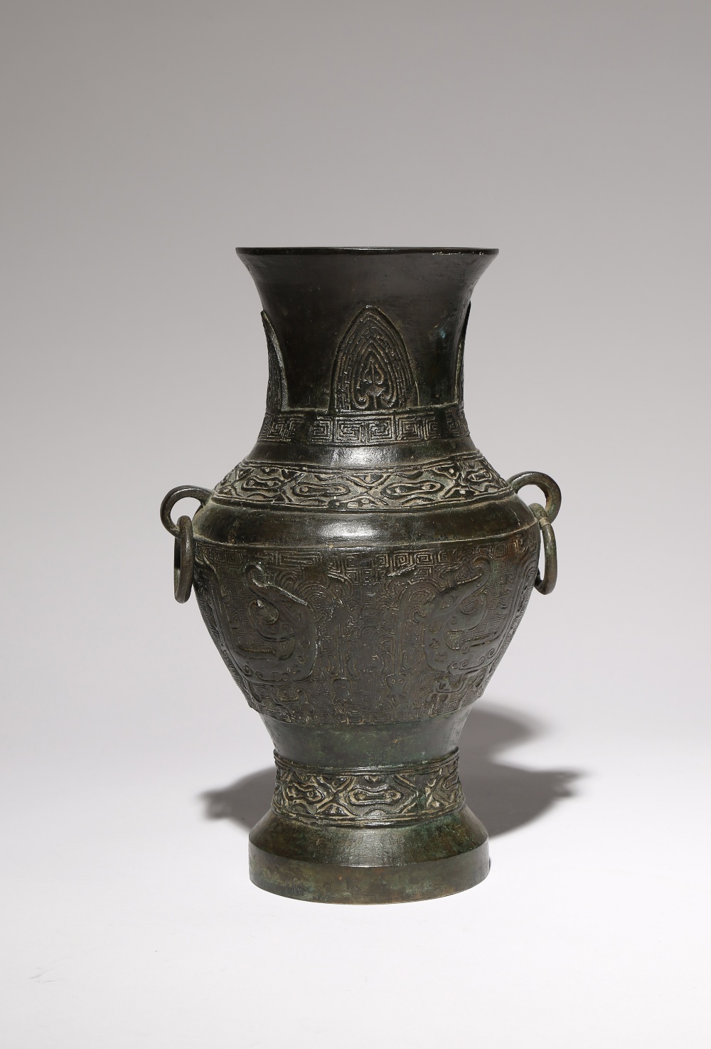 A CHINESE ARCHAISTIC BRONZE VASE MING/QING DYNASTY The ovoid body tapering towards the foot,