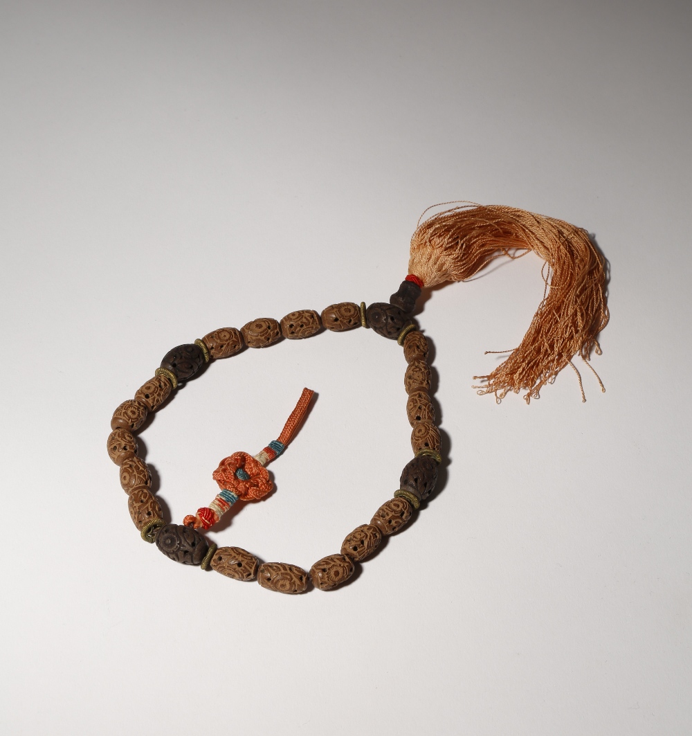 A CHINESE CARVED WOOD ROSARY BRACELET QING DYNASTY With eighteen small beads divided by four