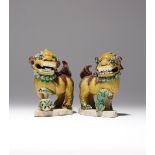 A PAIR OF SMALL CHINESE SANCAI MODELS OF LION DOGS KANGXI 1662-1722 The beasts depicted with bulging