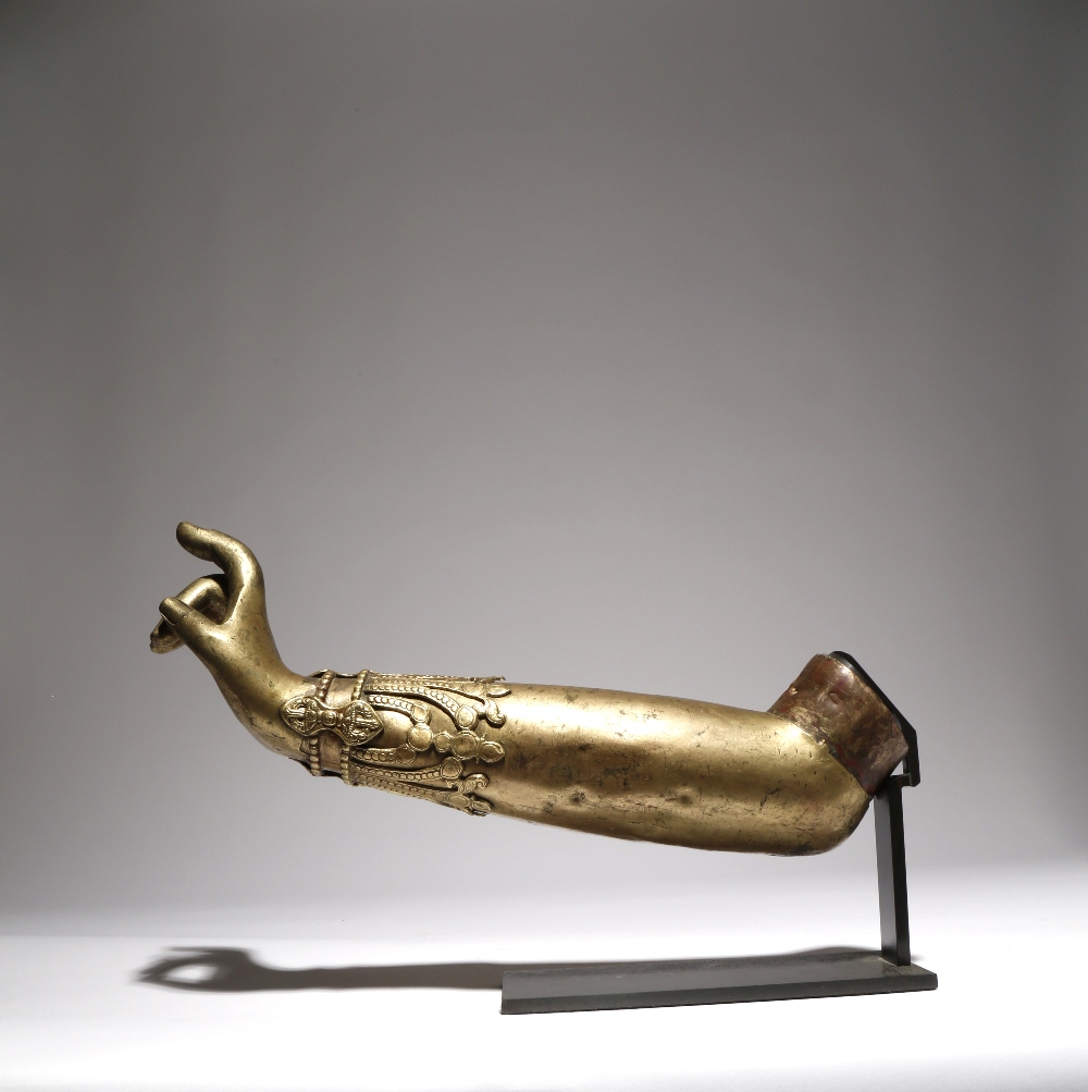 A TIBETAN GILT-COPPER BODHISATTVA'S ARM QING DYNASTY OR EARLIER The hand held in karana mudra,