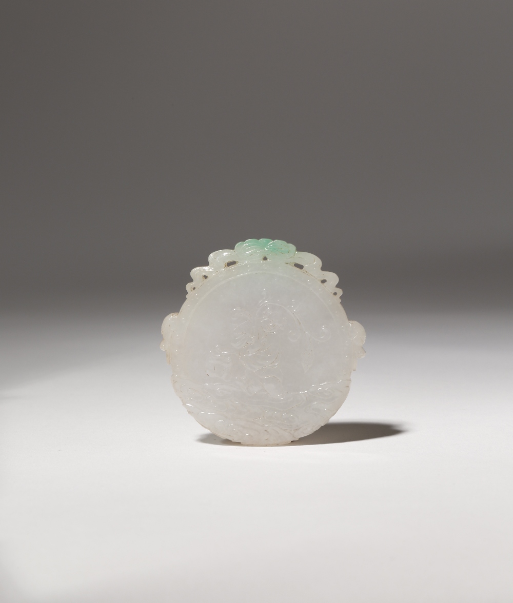 A CHINESE APPLE GREEN JADEITE CIRCULAR PENDANT LATE QING DYNASTY Carved to one side with a boy