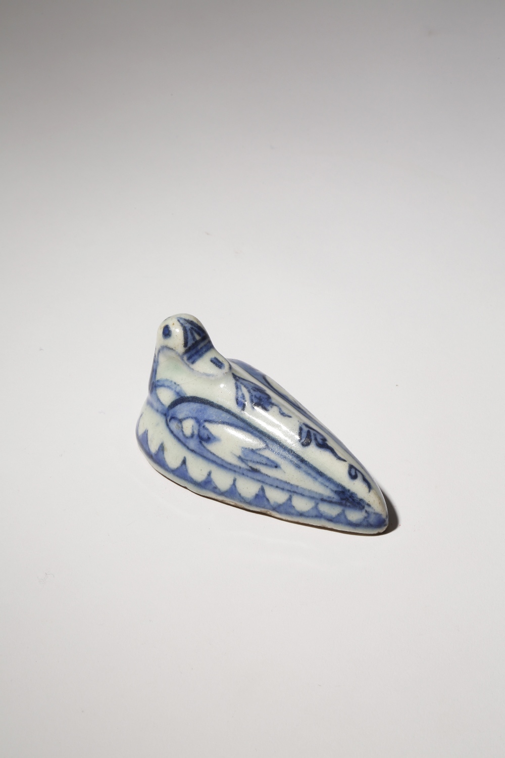 A QAJAR BLUE AND WHITE POTTERY 'PUMICE STONE' 18TH/19TH CENTURY Modelled as a seated bird painted