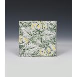 A Morris & Co Peony tile the designed by Kate Faulkner, painted with flower stems in yellow and