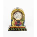 A Gouda Pottery Ivora mantel clock, domed rectangular form on stepped base, painted with stylised