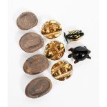 ‡Bimini Glass Ltd A set of three glass buttons, oval with cast decoration and gold highlights,