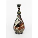 A Della Robbia Pottery Irish Clay bottle vase by J Delahunt, dated 1902, the pear shaped body with