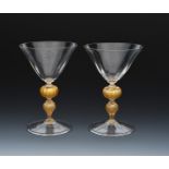 A pair of James Powell & Sons Whitefriars flint glass embedded gold goblets probably designed by