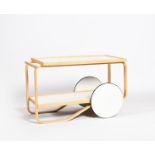 An Artek 901 drinks trolley designed by Alvar Aalto, dated 2005, birch with white laminate top,