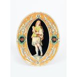 An unusual Minton & Co oval wall plaque, painted to the well with a classical figure holding a