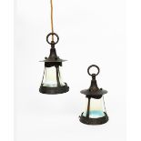 A pair of patinated copper and vaseline glass lanterns, flaring bell glass in strapwork frame,