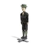 A FOLK ART CARVED AND PAINTED WOOD JIG DOLL LATE 19TH CENTURY of a man wearing a green hat, with