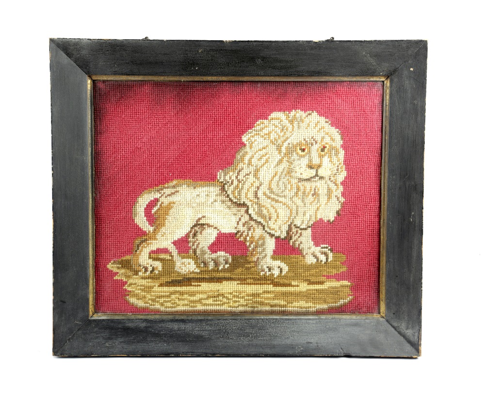 AN EARLY VICTORIAN WOOLWORK PICTURE OF A LION C.1840-50 depicted standing and with detailed