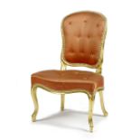 A GEORGE III GILTWOOD NURSING CHAIR IN THE FRENCH MANNER, LATE 18TH CENTURY the padded back and seat