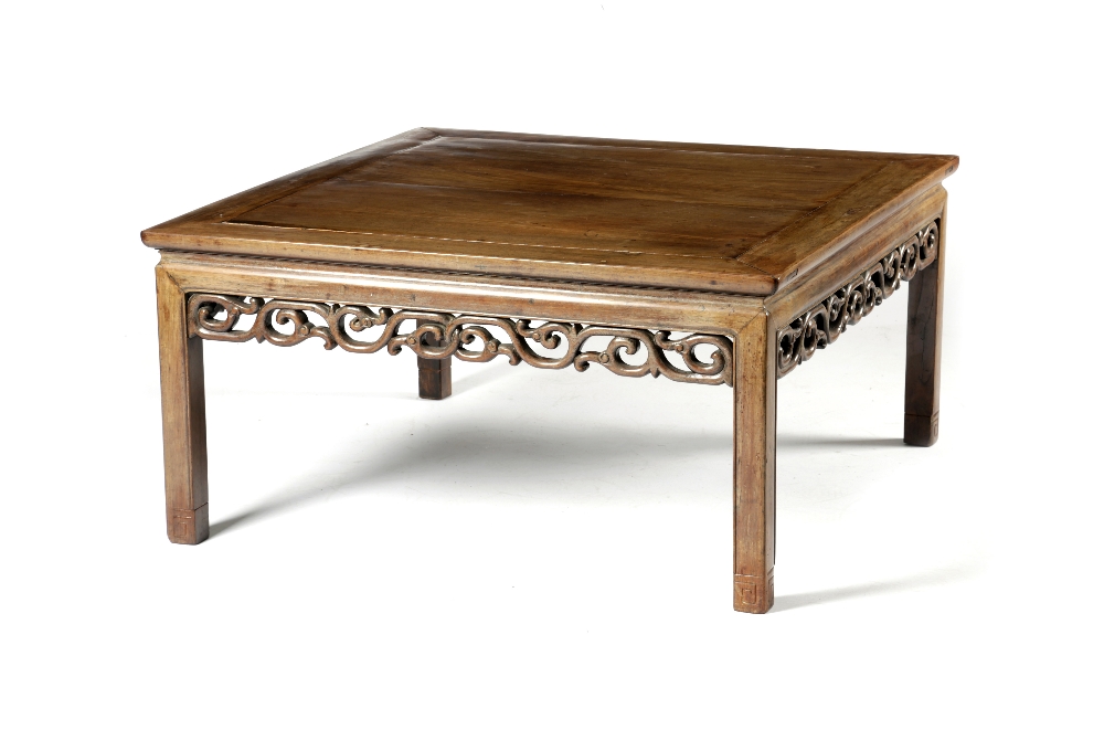 A CHINESE PADOUK KANG TABLE LATE 19TH CENTURY the panelled top above a plain frieze and a pierced