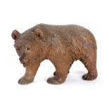 A BLACK FOREST CARVED LINDEN WOOD MODEL OF A STROLLING BEAR LATE 19TH / EARLY 20TH CENTURY with
