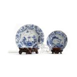 A SMALL CHINESE BLUE AND WHITE PORCELAIN DISH KANGXI (1662-1722) painted with panels of flowers, the