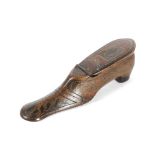 A TREEN SNUFF SHOE MID-19TH CENTURY with brass tack inlay and decorated with ebonised leaves, the