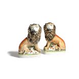 A PAIR OF STAFFORDSHIRE POTTERY LION AND LAMB GROUPS 19TH CENTURY each lion seated on its