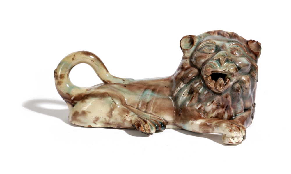 A STAFFORDSHIRE POTTERY MODEL OF A RECUMBENT LION LATE 18TH / EARLY 19TH CENTURY with a Whieldon-