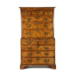A GEORGE II WALNUT CHEST ON CHEST C.1730 the moulded cornice above three short and three long burr