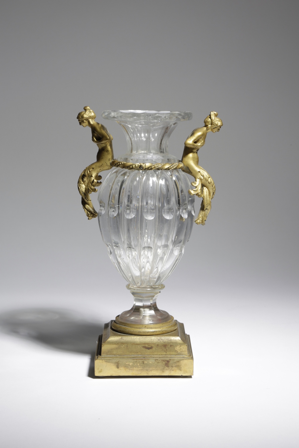 A FRENCH CUT-GLASS AND ORMOLU MOUNTED VASE LATE 19TH CENTURY the fluted and lobed urn shape glass