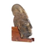 A CARVED STONE HEAD OF BODHISATTVA POSSIBLY THAI of flattened form, depicting a courtly lady, with a